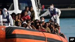 Migrants and refugees enter in the port of Roccella Jonica, Calabria region, southern Italy, Nov. 14, 2021.