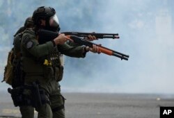 Police try to disperse protesters after a May Day march to protest pension cuts, school closures and slow hurricane recovery efforts turned violent, in San Juan, Puerto Rico, May 1, 2018.