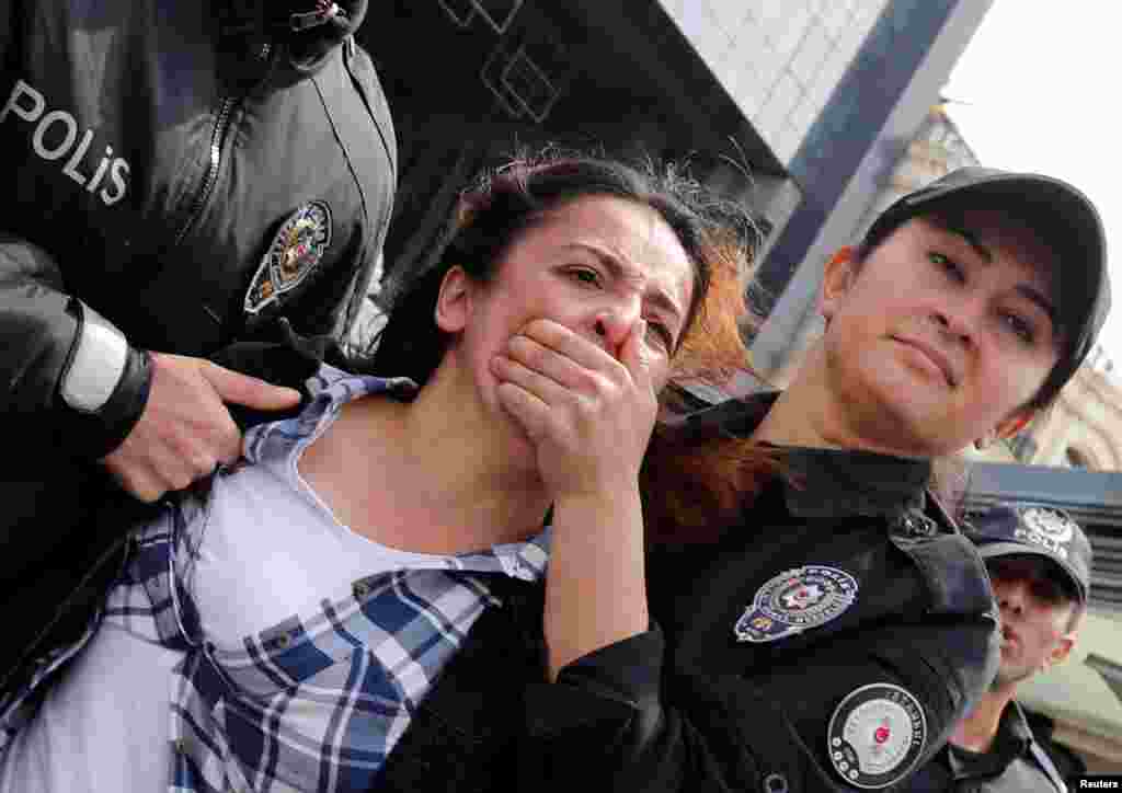 Police detain a protester after marching on Taksim Square to celebrate May Day in Istanbul, Turkey.