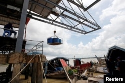 FILE - Swai fish is transported from a farming boat in the southern Mekong delta city of Can Tho, Vietnam, July 7, 2017.