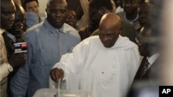 President Abdoulaye Wade casts his ballot for president at a polling station in Dakar, Senegal, Sunday, March 25, 2012.
