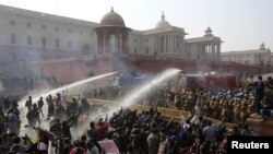 Police fire water canons on demonstrators near the presidential palace in New Delhi on Dec. 22, 2012.