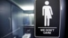A sign protesting a North Carolina law restricting transgender bathroom access is posted on bathroom stalls at a hotel in Durham, N.C. on May 3, 2016.