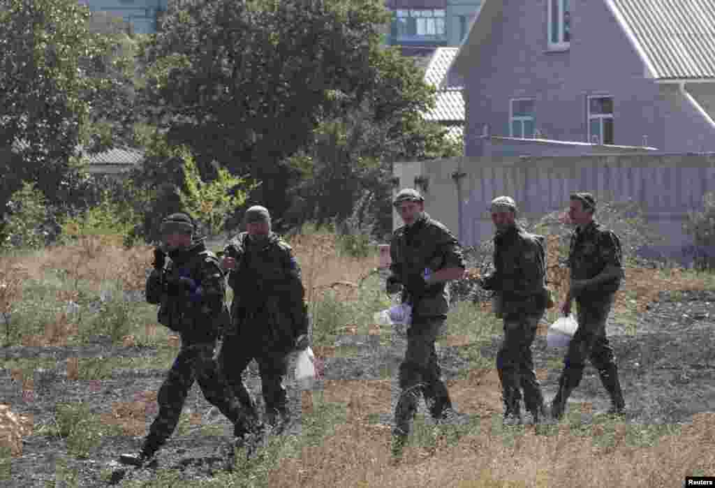 Soldiers of Ukrainian self-defence battalion "Azov" walk near a checkpoint in the southern coastal town of Mariupol, Sept. 5, 2014.