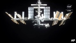 In this image from video provided by NASA, the International Space Station is seen as astronauts in the SpaceX Dragon capsule undock, Nov. 8, 2021.