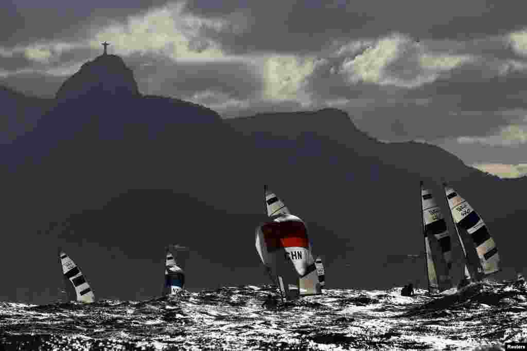 Sailors compete under the Christ the Redeemer statue at the Olympics in Rio de Janeiro, Brazil.