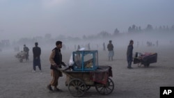 Street vendors push their carts in Chaman-e-Hozori park, Kabul, Afghanistan, Dec. 3 , 2021.