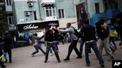 FILE - Pro-Ukrainian activists clash with pro-Russia activist during a pro Ukraine rally in Donetsk, Ukraine.