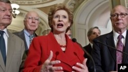 Senate Agriculture Committee members, led by Sen. Debbie Stabenow, D-Mich., center, praise bipartisan passage of the Farm Bill, Washington, June 21, 2012.