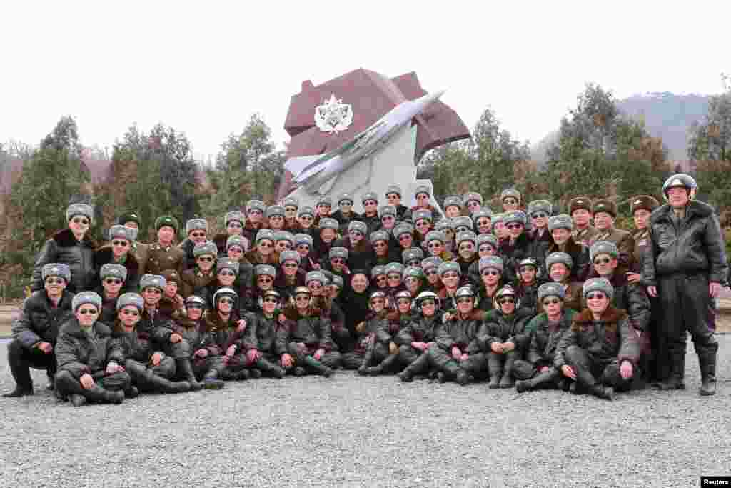 North Korean leader Kim Jong Un (center) visits Unit 447 of the Korean People&#39;s Army (KPA) Air and Anti-Air Force honored with the title of O Jung Hup-led 7th Regiment and plant trees with fighter pilots of the unit in this undated photo released by North Korea&#39;s Korean Central News Agency (KCNA) in Pyongyang, March 3, 2015.