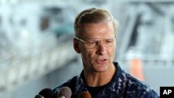 FILE - In this June 18, 2017, file photo, U.S. Navy Vice Adm. Joseph Aucoin, Commander of the U.S. 7th Fleet, speaks during a press conference, with damaged USS Fitzgerald as background at the U.S. Naval base in Yokosuka, southwest of Tokyo. U.S. official