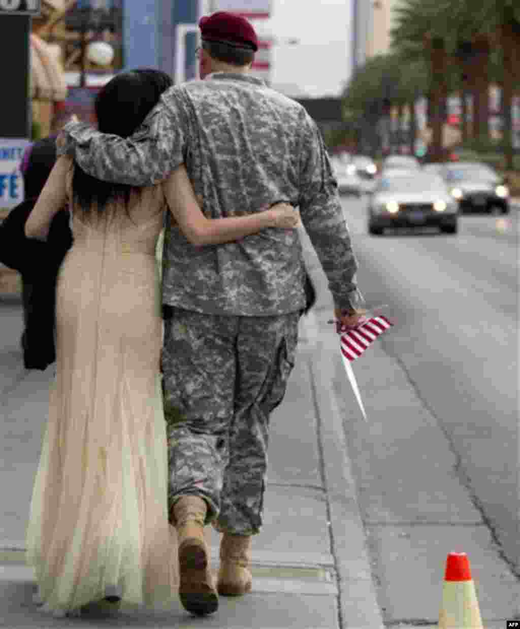 U.S. Army Master Sgt. Robert McLaughlin, right, of Suffolk, Va., and Karen Gold of Edinburgh, Scotland, walk down Las Vegas Boulevard after getting married at A Little White Chapel wedding chapel, Friday, Nov. 11, 2011, in Las Vegas. McLaughling, who join