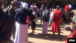 Some Zimbabweans waiting for cash outside a finance institution in the country. (Photo: Patricia Mudadigwa)