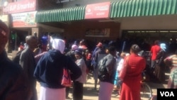 Some Zimbabweans waiting for cash outside a finance institution in the country.