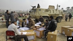 Election officials count ballots for the parliamentary elections in Cairo, Egypt, November 30, 2011.