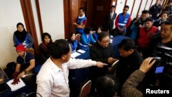 Keluarga penumpang pesawat Malaysia Airlines MH 370 memprotes petugas dari Malaysia Airlines seusai pertemuan di sebuah hotel di Beijing (19/3).