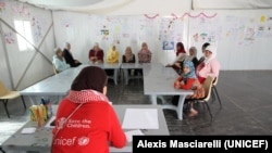 A discussion group organized by UNICEF and Save the Children in a Child Friendly Space in the Zaatari camp, where teenage girls discuss issues such as education, protection, family. Courtesy: UNICEF/Alexis Masciarelli