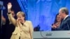 German Chancellor Angela Merkel waves next to Christian Democratic Union (CDU) leader and top candidate for chancellor Armin Laschet during his election rally in Stralsund, Germany, Sept. 21, 2021. 