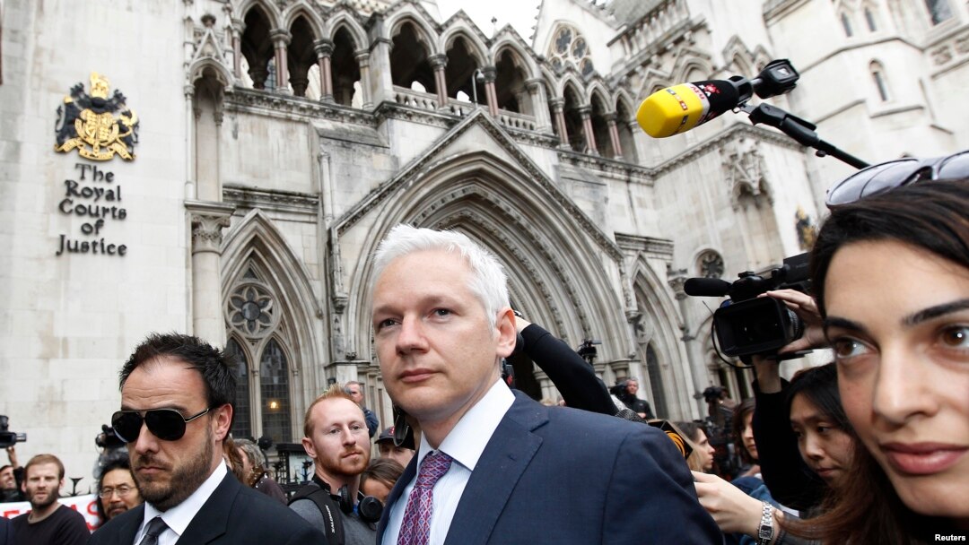 FILE - WikiLeaks founder Julian Assange leaves the High Court, with British lawyer Amal Alamuddin (R), in London, July 13, 2011.