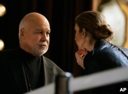 Canadian singer Celine Dion talks with her husband Rene Angelil during a break in her rehearsal at the Kodak Theatre in Los Angeles, Feb. 23, 2007.