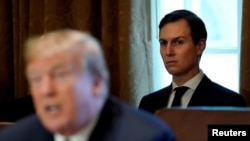 FILE - White House Senior Adviser Jared Kushner sits behind U.S. President Donald Trump during a cabinet meeting at the White House in Washington, Nov. 1, 2017.