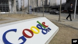A man walks past the Google company logo outside the Google China headquarters in Beijing (file)