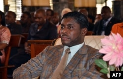 FILE - Teodorin Obiang Nguema, the son of Equatorial Guinea's president Teodoro Obiang Nguema sits during a mass at Malabo's Cathedral to celebrate his 41st birthday, June 25, 2013.