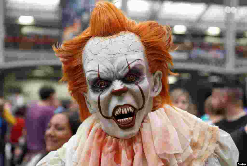 A person dressed as a Pennywise from the movie IT walks through the London Film and Comic Con event at Olympia in London, July 27, 2019.