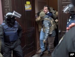 The Ukrainian Security Service officers detain Mikheil Saakashvili at the entrance to his building in Kyiv, Ukraine, Dec. 5, 2017.