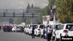 A convoy consisting of Red Cross, Red Crescent and United Nation (UN) gather before heading towards to Madaya from Damascus, and to al Foua and Kefraya in Idlib province, Syria, Jan. 11, 2016. 