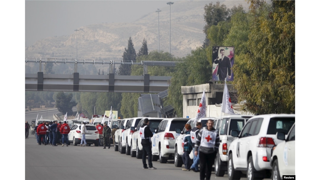 A convoy consisting of Red Cross, Red Crescent and United Nation gather before heading towards Madaya from Damascus, and to al Foua and Kefraya in Idlib province, Syria, Jan. 11, 2016.