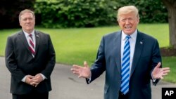 President Donald Trump, accompanied by Secretary of State Mike Pompeo, left, speaks to reporters on the South Lawn outside the Oval Office in Washington, June 1, 2018, after meeting with former North Korean military intelligence chief Kim Yong Chol.