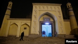 FILE - A man arrives at the Id Kah Mosque for morning prayers in Kashgar, Xinjiang Uighur Autonomous Region, China, March 23, 2017. 