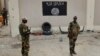 FILE - Soldiers stand at a checkpoint in front of a Boko Haram flag the Nigerian city of Damasak, Nigeria, March 18, 2015. 