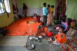 Penduduk desa beristirahat di tempat penampungan saat Topan Yaas bergerak menuju pantai timur India di Teluk Benggala. Topan Yaas diperkirakan akan menghantam Digha, sekitar 190 km dari Kolkata, 25 Mei 2021. (Foto: Dibyangshu SARKAR / AFP)