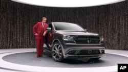 This undated photo provided by Chrysler shows Will Ferrell as 'Anchorman' character Ron Burgundy in an advertisement for the 2014 Dodge Durango.