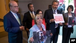 Democratic lawmakers shout in protest as President Donald Trump meets at the Capitol Tuesday, June 19, 2018, with House Republicans to discuss a GOP immigration bill. Congressional Hispanic Caucus Chair Rep. Michelle Lujan Grisham, D-N.M., center, holds a photo of a young boy at the border as she is joined by, from left, Rep. James P. McGovern, D-Mass., Rep. Adriano Espaillat, D-NY, Rep. Nanette Barragán, D-Calif., Rep. Juan C. Vargas, D-Calif., and Linda Sanchez, D-Calif.