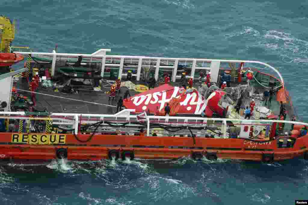 The tail of AirAsia QZ8501 passenger plane is seen on the deck of the Indonesian Search and Rescue ship Crest Onyx after it was lifted from the sea bed, south of Pangkalan Bun, Central Kalimantan, Jan. 10, 2015.