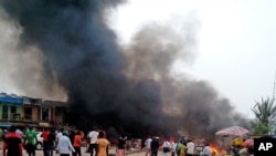 Smoke rises after a bomb blast at a bus terminal in Jos, Nigeria, May 20, 2014.