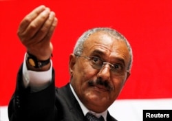 FILE - Yemen's then-President Ali Abdullah Saleh gestures during a gathering of supporters in Sana'a, Feb. 20, 2011.