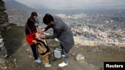 FILE - A boy receives polio vaccination drops during an anti-polio campaign in Kabul, Afghanistan, March 14, 2018.