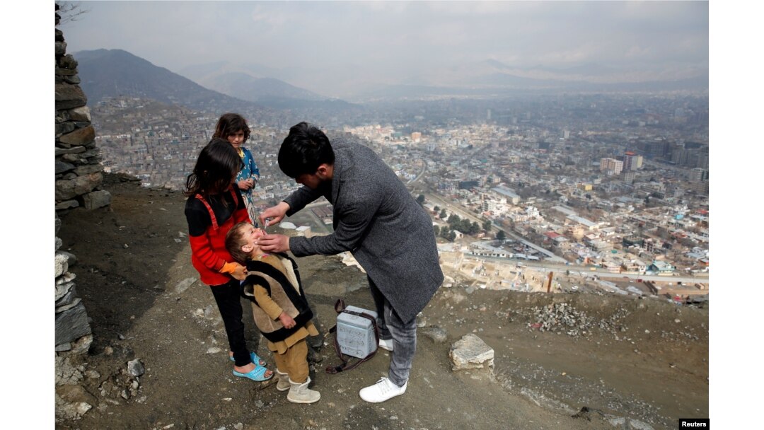 FILE - A boy receives polio vaccination drops during an anti-polio campaign in Kabul, Afghanistan, March 14, 2018.