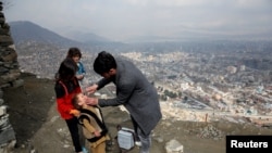 FILE - A boy receives polio vaccination drops during an anti-polio campaign in Kabul, Afghanistan, March 14, 2018.