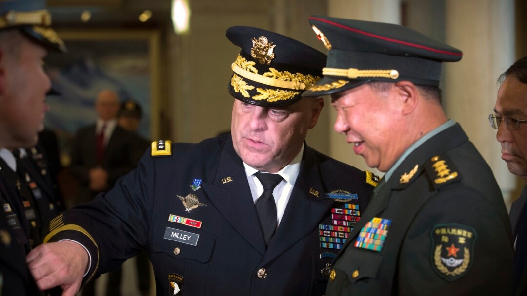 FILE - U.S. Army Chief of Staff Gen. Mark Milley, left, introduces members of his staff to China's People's Liberation Army (PLA) Gen. Li Zuocheng, right, during a welcome ceremony at the Bayi Building in Beijing, Aug. 16, 2016.