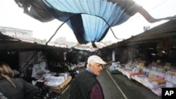 A man walks through a market in the town of Novi Pazar, Serbia, where Turkish goods are sold.