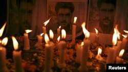 Candles are placed in front of the posters of Sarabjit Singh, who was convicted of spying for India and sentenced to death in Pakistan, during a candle light vigil to pay tribute in the northern Indian city of Amritsar, May 2, 2013.