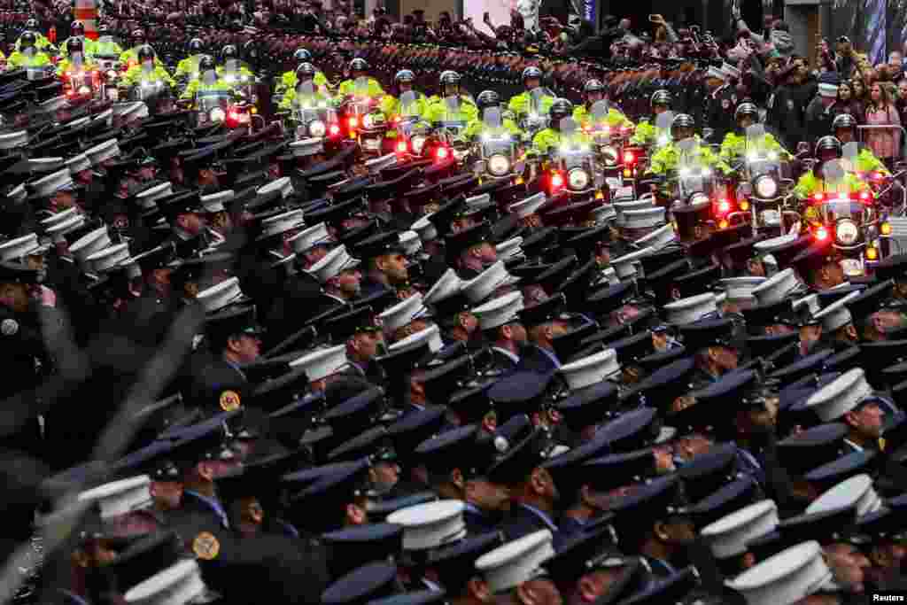 New York City firefighters attend a funeral service of firefighter and U.S. Marine Christopher Slutman, in New York City. 