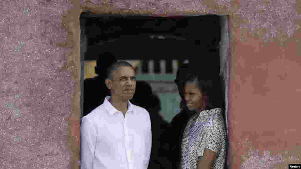 U.S. President Barack Obama and first lady Michelle Obama look out of a doorway that slaves departed from on Goree Island, Senegal, June 27, 2013. 