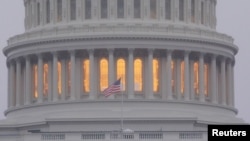 FILE - A United States flag flies in front of the U.S. Capitol dome in Washington, Nov. 6, 2018. U.S. intelligence officials warned on Oct. 22, 2024, that Russia and Iran are stepping up efforts to sow distrust and spark violence before and after the Nov. 5 presidential election.