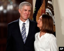 Judge Neil Gorsuch stands with wife Louise as President Donald Trump announces him as his choice for the Supreme Court at the East Room of the White House in Washington, Jan. 31, 2017.